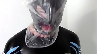 Tied Wife In Neoprene Suffers With A Plastic Bag