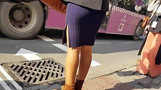 Girl In Shiny Tan Pantyhose And Mini Dress