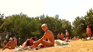 Lady In A Hat And Her Fat Husband Relax At The Beach